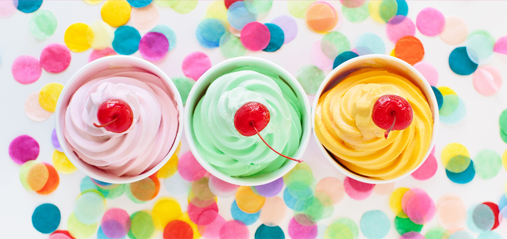 Three colorful cups of Menchie's frozen yogurt
