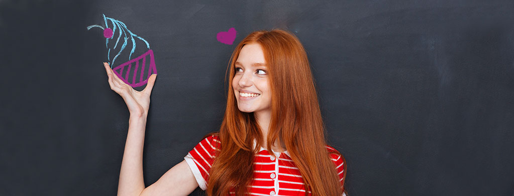 A girl holding a chalk drawing of a frozen yogurt cup