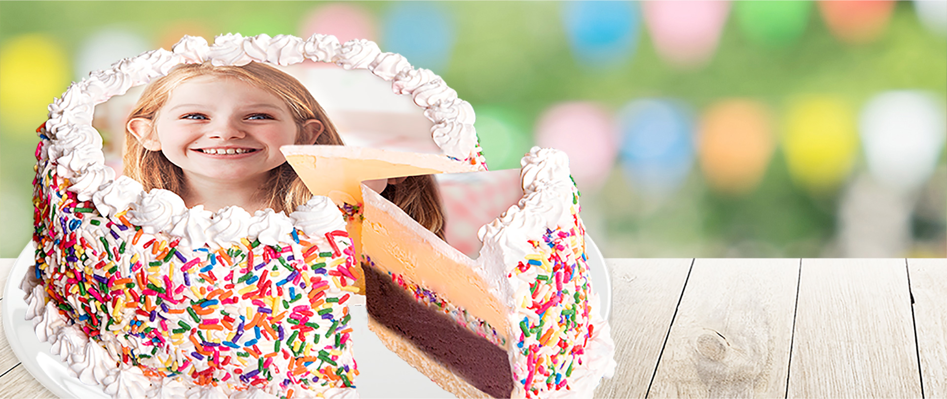 A photo of a girl smiling on top of a Menchie's cake