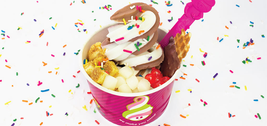 A cup of Menchie's frozen yogurt with various toppings